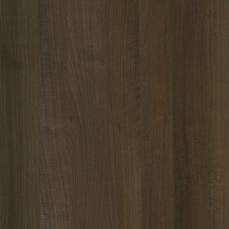 A close-up image of a dark wood surface with a rich, warm brown tone. The wood grain is visible, showing natural variations and textures, adding depth and character to the material.